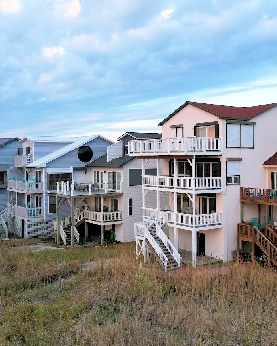 Beach houses standing on stilts above the dune grass at Ocean Isle Beach