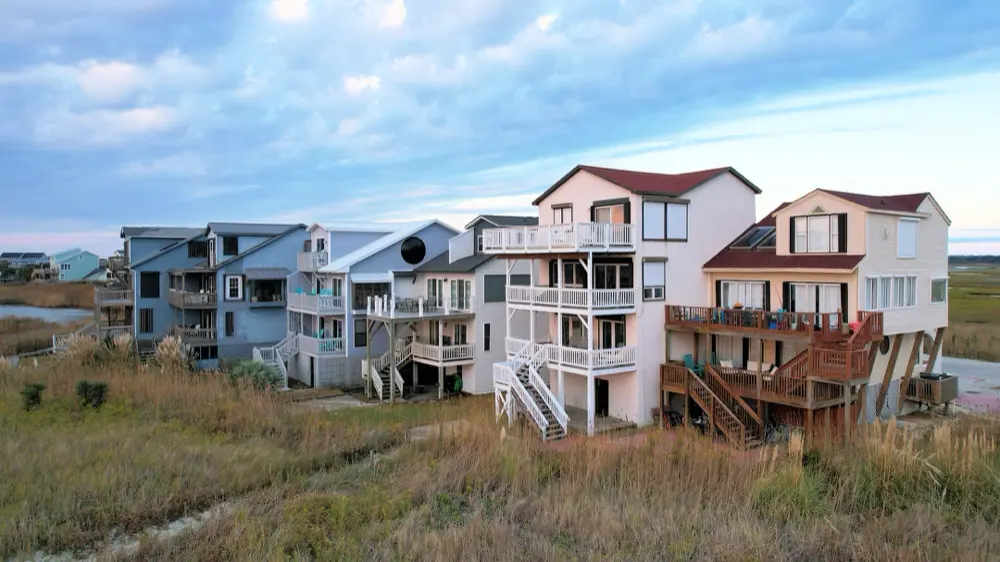 Row of oceanfront beach houses behind the dunes at Ocean Isle Beach