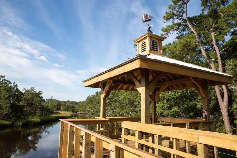 Covered wooden observation deck over the tidal creek on the Shallotte riverwalk